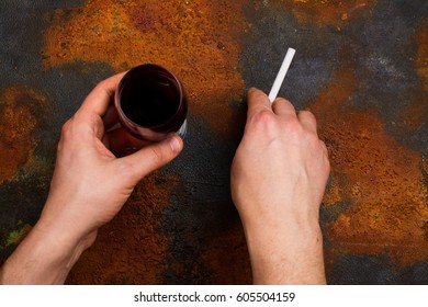 Man Holding Cigarette And Glass Of Red Wine In His Hands. Bad Unhealthy Habits Or New Year Resolution Concept. Copy Space