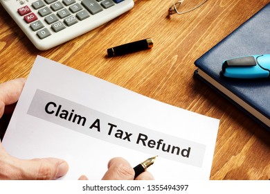 Man Is Holding Claim A Tax Refund Documents.