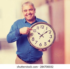 man holding a clock