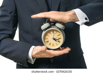 Man holding clock on white background, closeup. Time management concept - Shutterstock ID 1070426150
