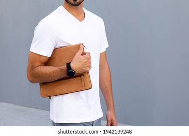 Man Holding Clutch Walking In The City