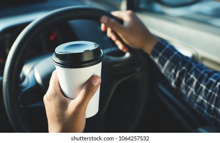 Man Holding Coffee Paper Cup In Car