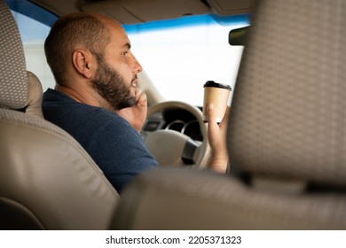 Man Holding Coffee Paper Cup In Car. Enjoy A Cup Of Coffee Takeaway To Go To Keep You Concentrated On The Way To Work Or Holidays.