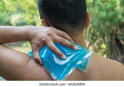 Man Holding Cold Pack With Compression Back Muscles