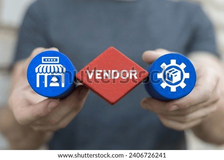 Man holding colored blocks sees inscription: VENDOR. Vendor Seller Business concept. Shop, market, vendor management.