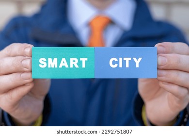 Man holding colorful styrofoam blocks with inscription: SMART CITY. Concept of smart city with smart services, internet of things (IOT), AI, networks, big data, augmented reality. - Powered by Shutterstock