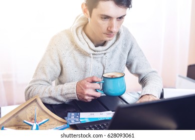 Man holding a credit card and buys plane tickets on the Internet working on the laptop. The concept of travel and transport, buying and booking