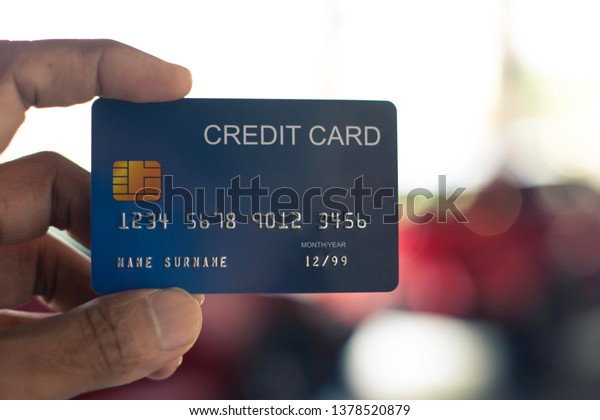 man holding credit card for car blurred bokeh\
background e-shopping \
\
\
marketing digital, consumer purchase\
shopping internet online\
image\
\

