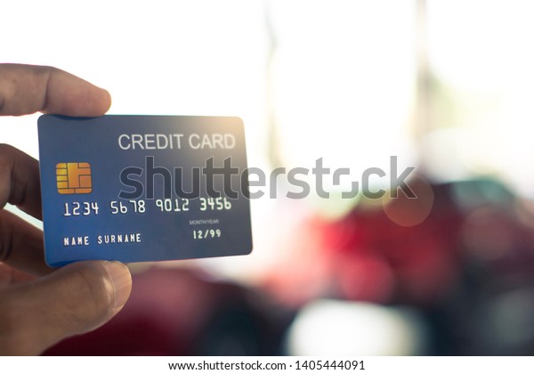 man holding credit card for car blurred bokeh\
background e-shopping \
marketing digital, consumer purchase\
shopping internet online\
image\
