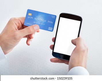 Man Holding Credit Card And Cell Phone Checking Account Balance