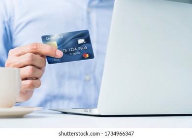 Man holding a credit card for online shopping - Shutterstock ID 1734966347