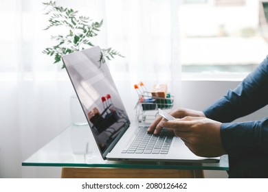 Man Holding credit card and using a laptop with shopping online to buy a gift for girlfriend at the cafe. Black Friday and shopping online Concept.  - Shutterstock ID 2080126462