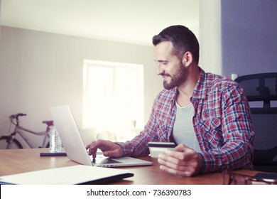 Man Holding Credit Card And Using Laptop. Online Shopping