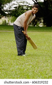 Man Holding Cricket Bat