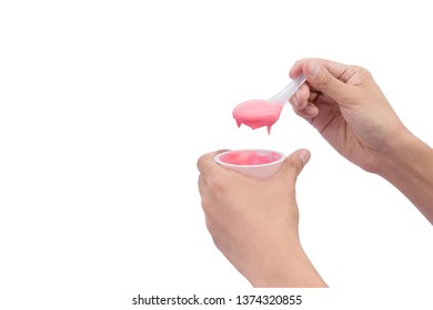 Man holding a cup of yogurt and spoon in hand isolated on white background.People eating yogurt, strawberry flavor