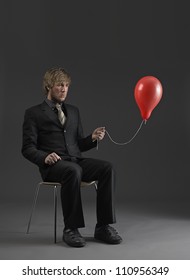 Man Holding A Deflated Balloon