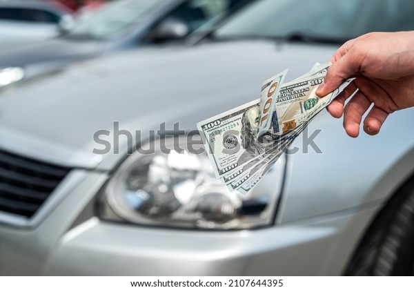 Man holding dollars for rent or buy car. success\
deal concept