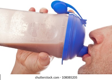 Man Holding And Drinking The Post Workout Chocolate Whey Protein Shake, Isolated On White