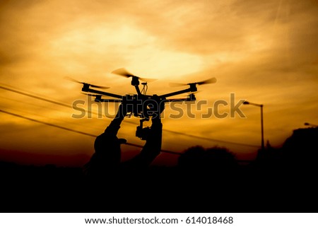 Man holding drone preparing for take of.