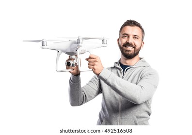 Man holding drone. Studio shot on white background, isolated
