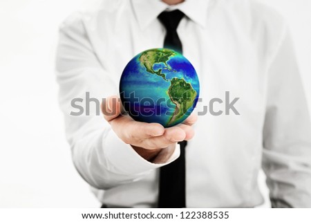 Man holding a earth globe in his hand, Earth image provided by Nasa -http://www.nasa.gov/topics/earth/earthday/gall_ocean_chrom.html