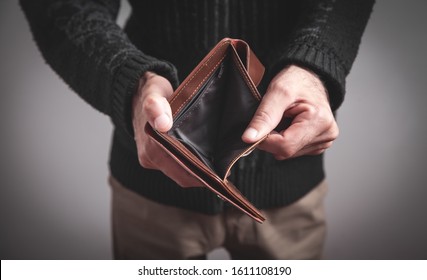 Man Holding Empty Wallet. No Money