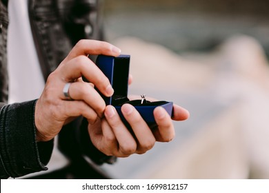 Man Holding Engagement Ring In Box For Proposal. Engagement Ring Box Close Up