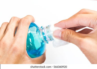 Man Holding Ethyl Alcohol Bottle And Cotton Ball