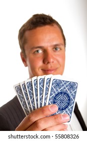 A Man Holding Up A Few Playing Cards