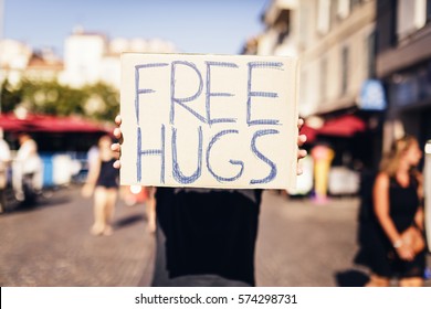 Man Holding Free Hugs Sign In European City