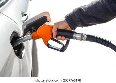 Man holding gas hose, gasoline pump nozzle isolated on white background. Fuel nozzle with the hose, Pumping gasoline fuel in car at a petrol station, Copy Space. 