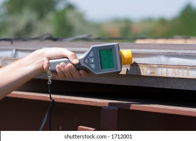 Man Holding A Geiger Counter