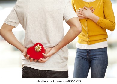 Man Holding  Gift Box Behind His Back