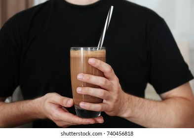 Man Holding Glass With Protein Shake Indoors