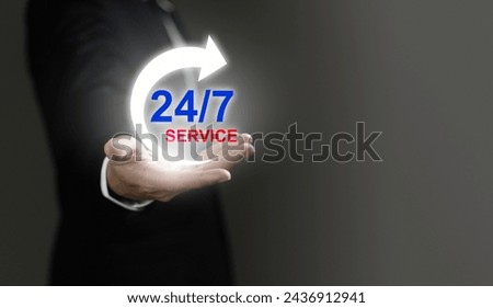 A man is holding a glowing hand with a 247 service logo on it. Concept of urgency and importance, as the 247 service is always available to assist