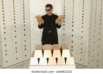 Man Holding Gold Bullion In A Strongroom