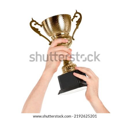 Man holding gold trophy cup on white background, closeup