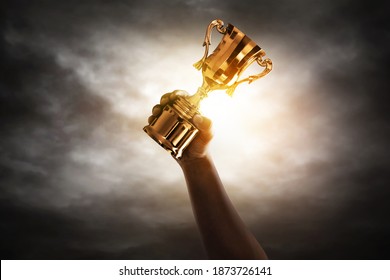 Man Holding Golden Trophy Cup