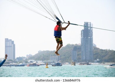 Man Holding Gopro Camera In Hand On Parachute Ride With Gopro Camera In Hand In Air Flight Background Blue Sky Travel Summer, Para Sailing In Pattaya City Thailand ,9th February 2019