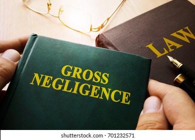 Man Holding Gross Negligence Book.