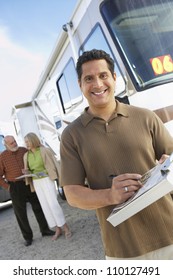 Man holding guide book with passengers in the background