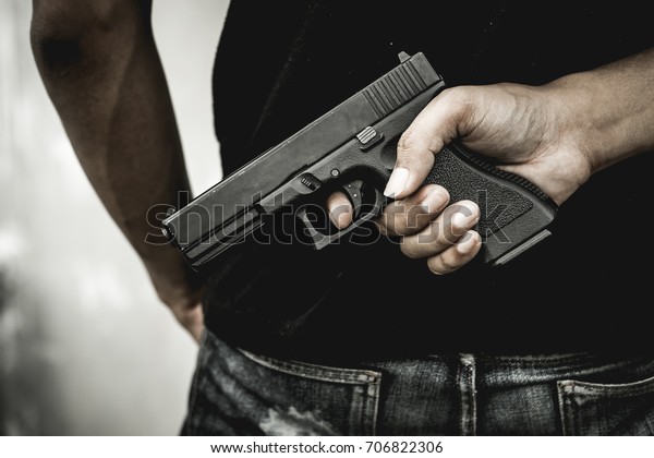 A man\
holding a gun in hand, the ship ready to shoot the man pointed a\
gun at us. A man holding a gun was\
robbed.