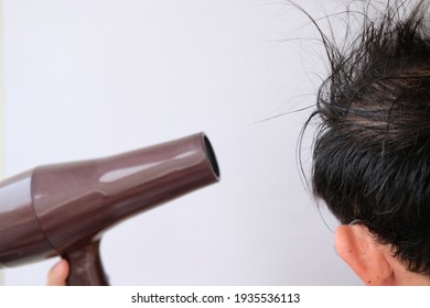 Man Holding Hair Dryer On White Background