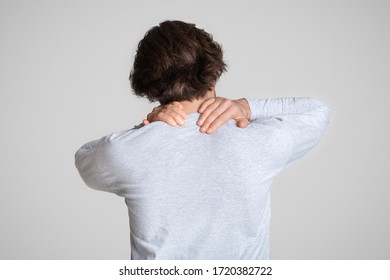 Man holding hand in neck pain area, free space