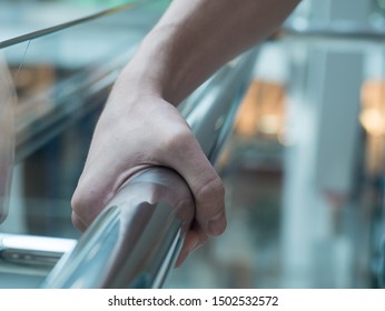 Man Holding A Hand Rail In Mall Closeup