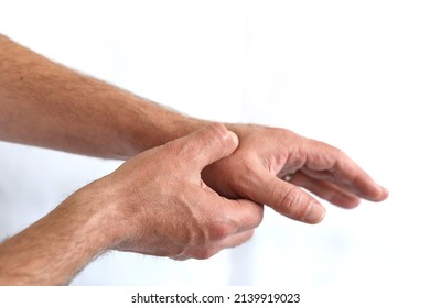 Man Holding Hand With Thumb Pain Problem Point Out Hurt Area With Red Gradient Color, Isolated On White With Copy Space For Text.