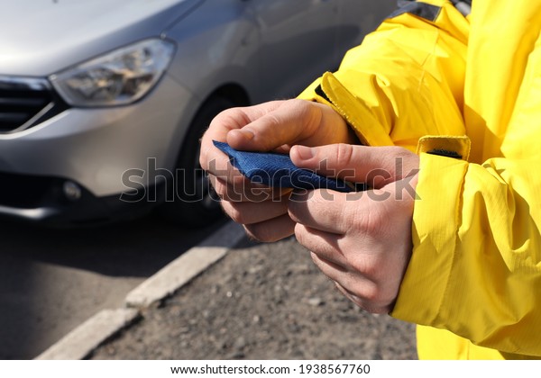 Man holding hand\
warmer on street, closeup