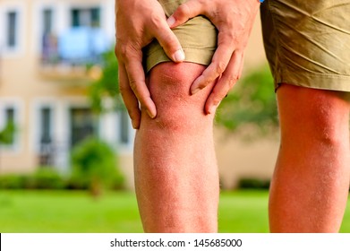 Man Holding Hands Sore Knee