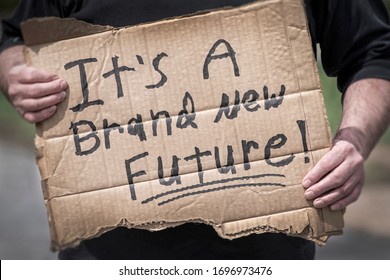 Man Holding Handwritten Cardboard Sign, It's A Brand New Future, Coronavirus Global Pandemic, Hope, Change, Pivot, Adapt, Job, Employment, Economy, Uncertainty, Positive Thinking, Win, Victory, 