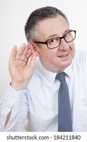 Man Holding His Ear To Hear Better